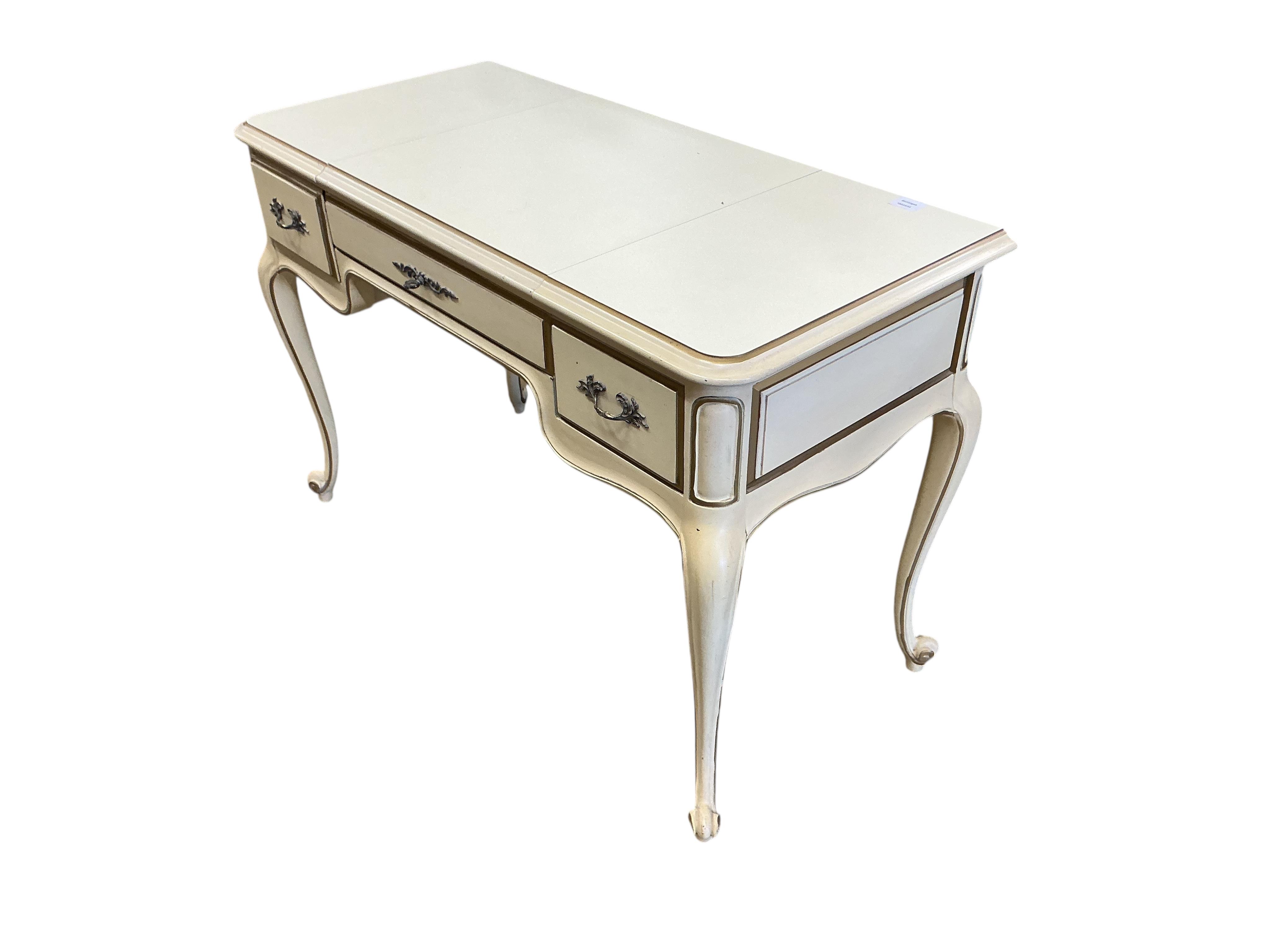 An American cream and gilt painted dressing table, width 112cm, depth 51cm, height 75cm